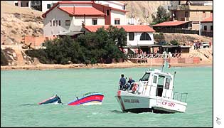 An Italian boats patrols the area of the wreck