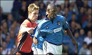 Gary Flitcroft tries to stop Manchester City's Shaun Goater in his tracks