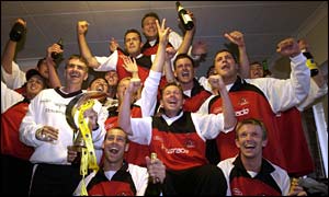 The Glamorgan players celebrate becoming Norwich Union League champions