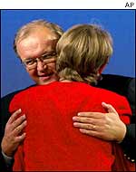 Goeran Persson hugs Party of the Left leader Gudrun Schyman