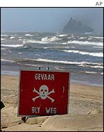 Warning sign posted on beach near stricken freighter