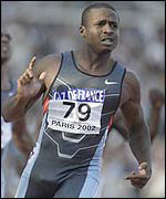 Tim Montgomery crosses the line in Paris