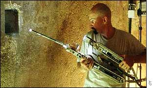 Engineer Gregg Landry from Boston firm iRobot prepares to insert the camera in a specially drilled 