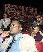 The audience listens intently