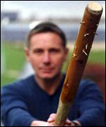 Man holding nail-studded bat