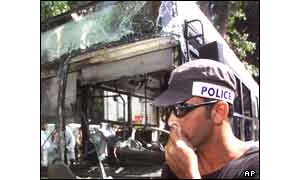 Policeman by bombed bus