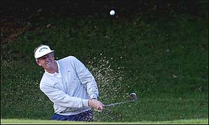 Colin Montgomerie plays out of a bunker in Ireland