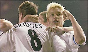 Michael Bridges is congratulated by Alan Smith (right) after Leeds' goal