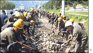 North Korean workers being work on North-South railway