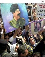 Crowd with poster of Saddam Hussein