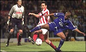 Stoke's Peter Handyside tackles Russell Earnshaw as Cardiff try to extend their first leg advantage