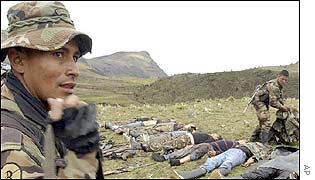 Colombian soldiers stand guard near to bodies of FARC rebels after an operation to free civilians kidnapped by the insurgents