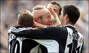Alan Shearer is congratulated by team-mates after scoring Newcastle's second goal