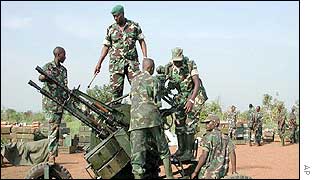 Rwandan soldiers dismantle a gun