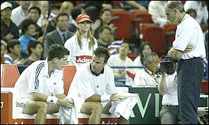 Team captain Roger Taylor offers advice to Henman and Maclagan after they go a break up in the second set