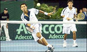 Danai Udomchoke looks on as his team mate Paradorn Srichaphan hits a return as the British pair grab the momentum in the second set