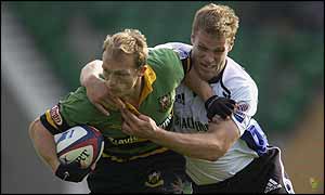Northampton scrum-half Matt Dawson is tackled by Bath's Andy Beattie