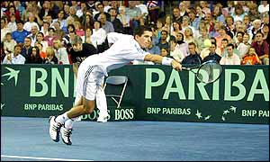 Henman stretches for a volley as he and Maclagan level the match, taking the second set 6-4