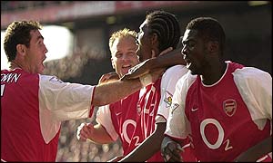 Kanu is congratulated by his Arsenal team-mates