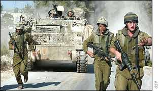 Troops run towards the Ramallah HQ of Mr Arafat