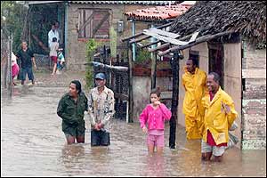 People stand in the floodwaters in western Cuba