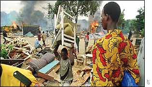 Man carries possessions from his home in Abidjan