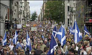 Protesters waving saltires