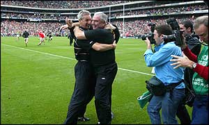 Fitness coach John McCluskey gives manager Joe Kernan a hug at the end