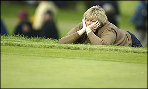 A dejected Laura Davies watches from the edge of a green