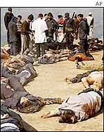 Security personnel survey the site of a rebel attack