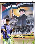 A man in front of an poster in Iraq