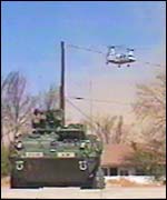 An armoured personnel carrier and helicopter in recent war games