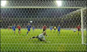 Fabien Barthez is beaten by Berbatov's header but the ball stays out