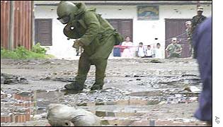 Nepalese bomb disposal expert approaches a suspected bomb left by the rebels