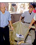 Paramedics receive a battle casualty at a Nepalese hospital 