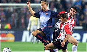 Bergkamp works hard to hold onto possession for the Gunners