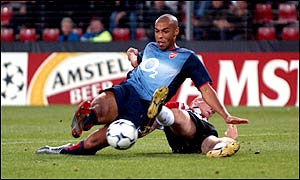 Henry shrugs off a last-ditch tackle to put the game beyond doubt with Arsenal's third goal