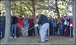 Northern Ireland's Darren Clarke plays out of the trees