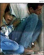 Palestinian boy Muhammad al-Durrah shelters behind his father