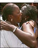 Two Senegalese women embrace