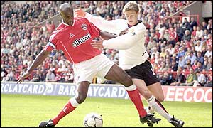 Rufus and Solskjaer tussle for the ball at the Valley
