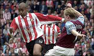 David Bellion (left) takes on Steve Staunton
