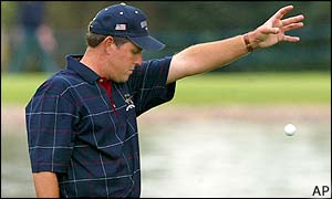 Davis Love III drops his ball after a wayward shot at the eighth helps Europe go 2 up