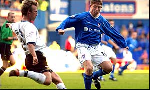 Derby's Warren Barton clears from Alun Armstrong