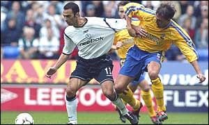 Bolton's Youri Djorkaeff holds off Claus Lundekvam