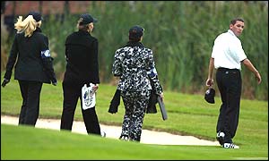 Sergio Garcia of the European team is followed from the 18th green by his mother