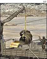 Crane loading equipment onto an army lorry