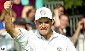 Padraig Harrington clenches his fist in delight after grabbing Europe's second win of the day