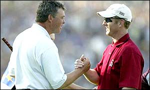 Darren Clarke and David Duval shake hands and share the honours after a close match ends level; Europe lead 11� - 9�