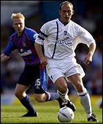 Gillingham's captain Paul Smith runs away from Aki Riihilahti of Crystal Palace 